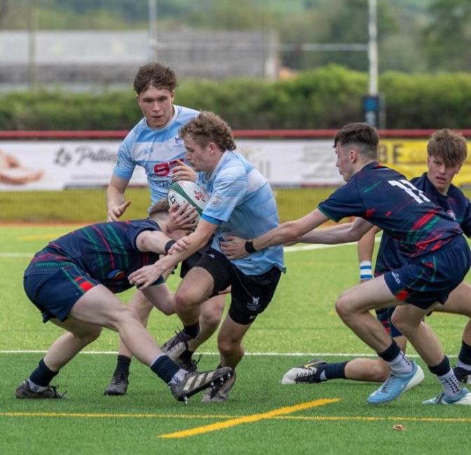 Ollie Thompson brushes aside tacklers